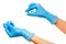 Close up of female doctor\'s hands in blue sterilized surgical gloves with green plastic catheter against white