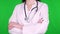 Close-up, female doctor, surgeon, dressed in a white medical uniform and with a stethoscope, standing with crossed hands