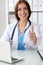 Close up of female doctor thumbs up. Happy cheerful smiling brunette physician ready to examine patient. Medicine