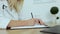 Close up female doctor writing notes in registration album, managing patients appointments at workplace. Medicine