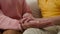 Close-up female elderly hands holding hand of child unrecognizable loving tender grandmother support grandson kid boy