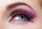 Close up of female eye with brilliant pink makeup