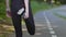 Close-up Female feet on jogging track getting ready to jog. Slim sporty woman runner jogger in black tracksuit stretches