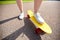 Close up of female feet riding short skateboard