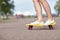 Close up of female feet riding short skateboard