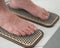 Close-up of female feet on sadhu boards.
