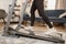 Close-up of female feet sneakers woman treadmill running in a modern apartment