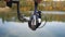 Close-up of a female fisherman with a rod spinning a spinning reel. Fishing in a pond with a line pulling