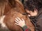 Close up of female forming bond with a piebald pony