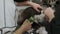 Close-up of a female groomer shaving a cat in an animal salon.