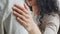 Close-up female hand with natural manicure lies on male shoulder embracing. Unrecognizable curly girl woman wife holding