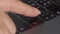 Close-up female hand pressing enter button on laptop keyboard