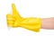 Close up of female hand in yellow protective rubber glove in foam showing thumbs up sign