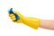 Close up of female hand in yellow protective rubber glove squeezing blue cleaning sponge