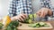 Close-up female hands chopping fresh organic cucumber using knife cooking healthy food salad