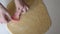 Close-up, female hands cut out of raw dough blanks for cookies in the shape of a heart. A woman cooks in a home kitchen