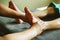 Close-up of female hands doing foot massage.