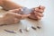 Close-up of female hands doing hardware manicure at home. Nozzles for the manicure tool on the table