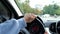 Close up of female hands driving car on driver\'s licence exam. Woman hands on steering wheel turning left and right