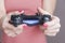 Close-up of female hands with gamepad while playing