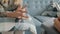 Close-up of female hands holding tissue while nervous woman talking to therapist in office