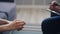 Close up of female hands holding tissue and psychologist writing notes in office