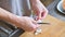 Close-up of female hands at home kitchen clean garlic from the peel. Shallow depth of field