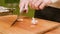 Close-up of female hands at home kitchen clean garlic from the peel. Shallow depth of field