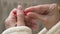 Close-up of female hands with an interdental brush in the bathroom against the background of the sink. Professional care