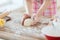 Close up of female hands kneading dough at home