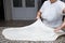 Close up of female hands kneading dough and making banitsa