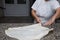 Close up of female hands kneading dough and making banitsa