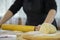 Close up female hands kneading yeast dough on table sprinkled with flour