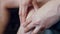 Close-up of female hands making a massage on man\'s knee