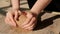 Close-up female hands mixing clay ball before working on a pottery wheel