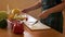 Close-up, female hands are mixing vegetable salad in a bowl. The girl tastes a salad with a spoon. Housewife prepares a