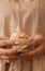 Close-up of female hands with a neat manicure hold a baby cake