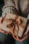 Close up on female hands opening the gift, untying the ribbon