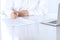 Close-up of female hands with pen over document, business concept. Lawyer or business woman at work in office