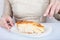 Close-up of female hands and a piece of meat pie