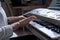 Close-up of female hands playing the synthesizer, shallow depth of field