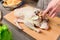 Close-up of female hands preparing duck or goose for baking. White carrot dressing with mayonnaise. Christmas dish duck