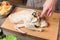 Close-up of female hands preparing duck or goose for baking. White carrot dressing with mayonnaise. Christmas dish duck