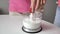 Close-up, female hands put strawberries in milk in transparent cup for a blender