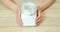 Close up of female hands putting a bowl of white flour on a table