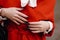 Close up female hands on a red classic jacket.