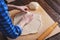 Close-up of female hands rolling out a ball of pizza dough cooking at home