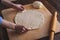 Close-up of female hands rolling out a ball of pizza dough cooking at home