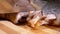 Close-up of female hands slicing smoked eel into portions on a board