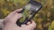 Close up of female hands taking pictures of a green leaves of a bush on a smartphone. Action. Amazing quality of a